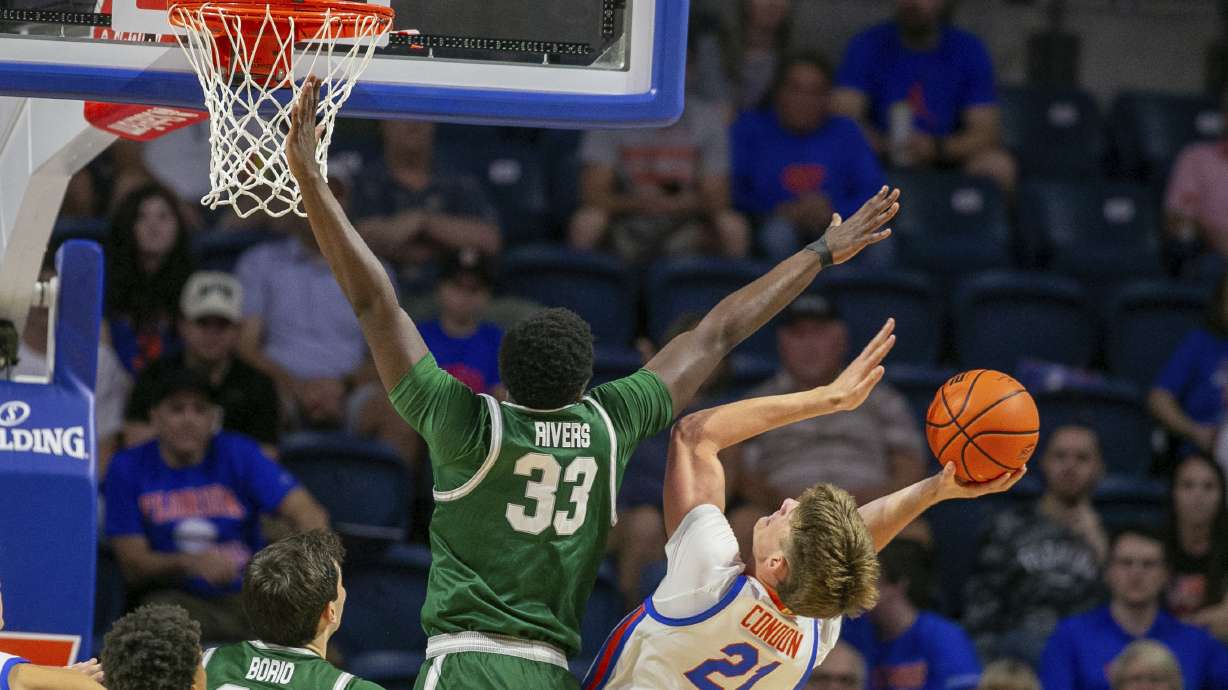 Jacksonville forward Donovan Rivers (33) blocks the shot of Florida forward Alex Condon (21) during the first half of an NCAA college basketball game Thursday, Nov. 7, 2024, in Gainesville, Fla.
