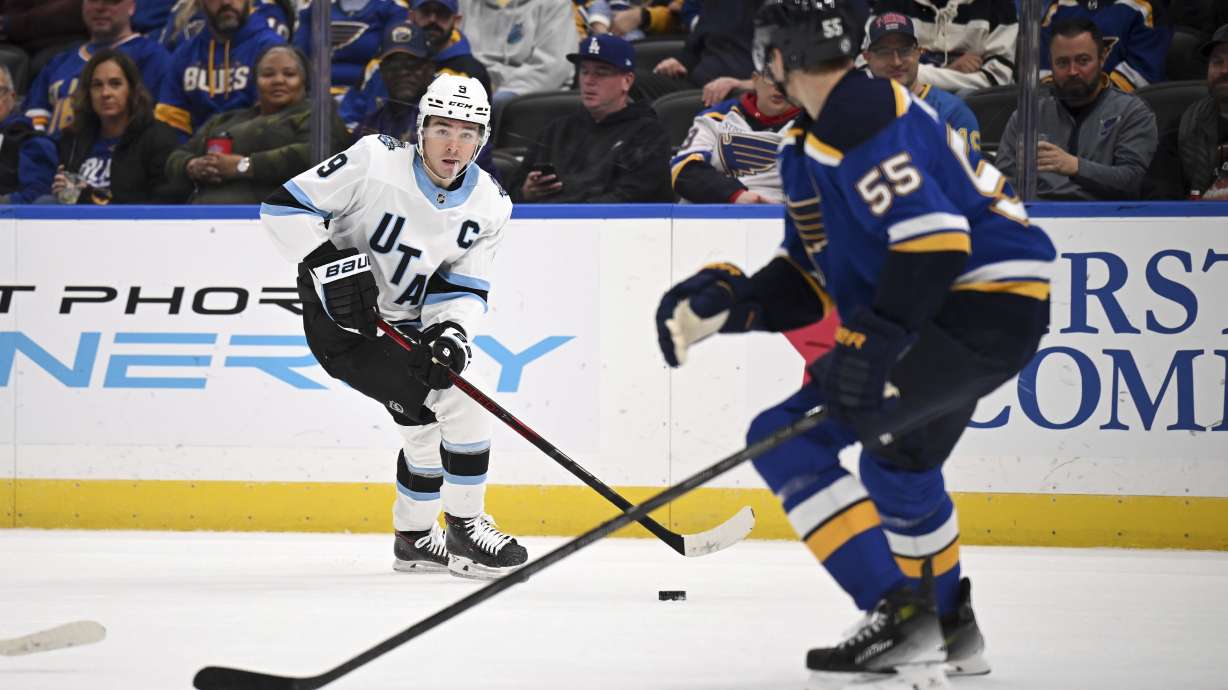 Utah Hockey Club's Clayton Keller (9), left, controls the puck as St. Louis Blues' Colton Parayko (55) defends during the first period of an NHL hockey game Thursday, Nov. 7, 2024, in St. Louis.
