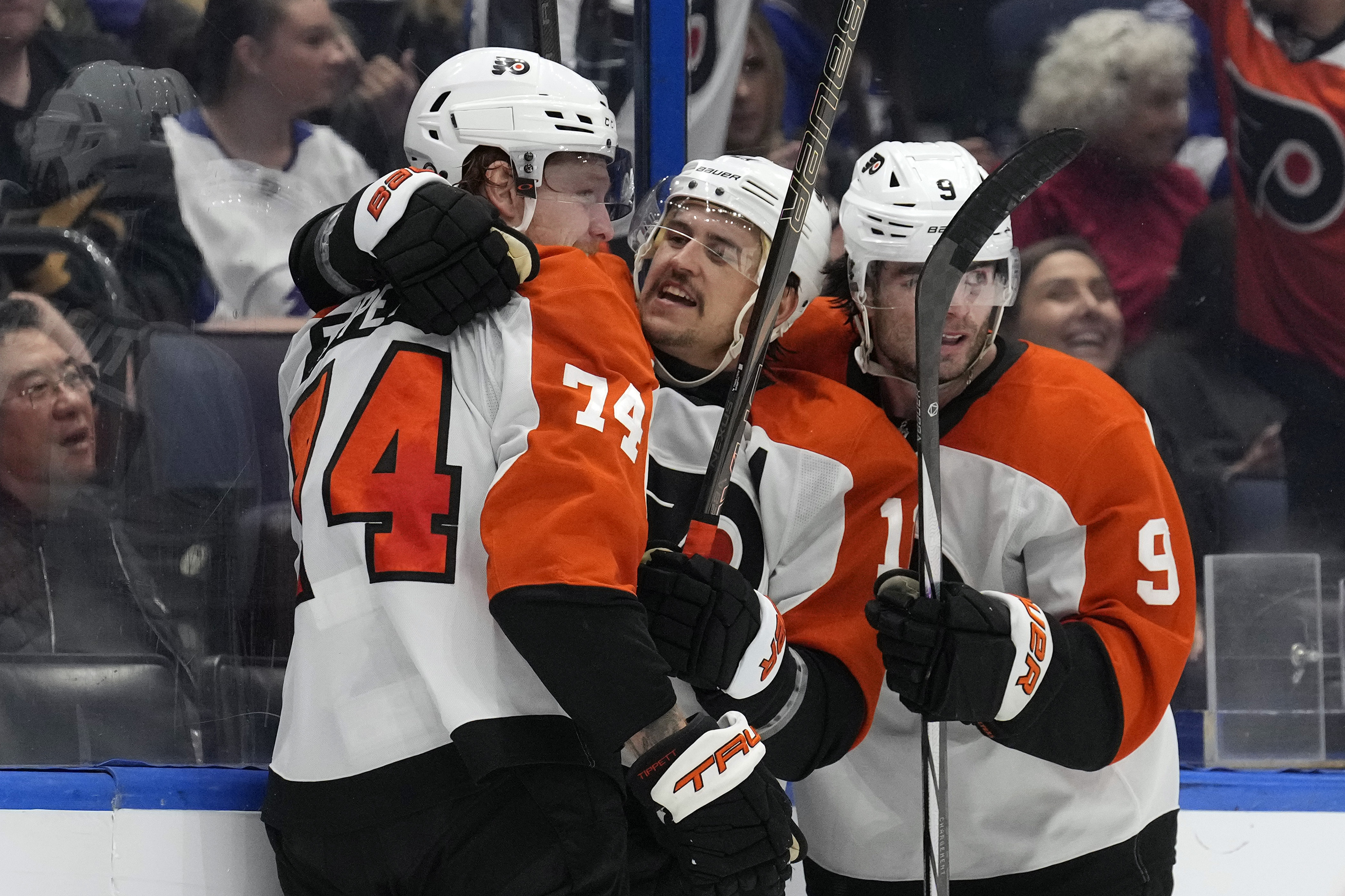 Philadelphia Flyers right wing Owen Tippett (74) celebrates his goal against the Tampa Bay Lightning with right wing Travis Konecny (11) and defenseman Jamie Drysdale (9) during the third period of an NHL hockey game Thursday, Nov. 7, 2024, in Tampa, Fla.