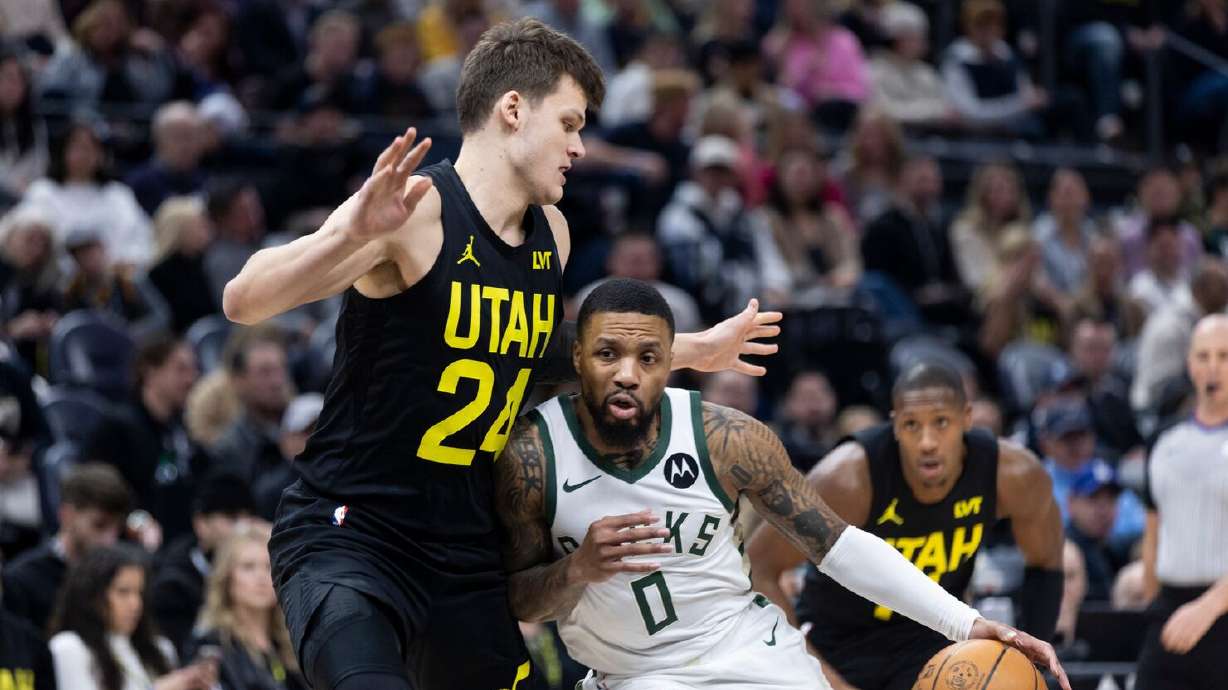 Utah Jazz center Walker Kessler (24) blocks Milwaukee Bucks guard Damian Lillard (0) during an NBA game at the Delta Center in Salt Lake City on Sunday, Feb. 4, 2024.