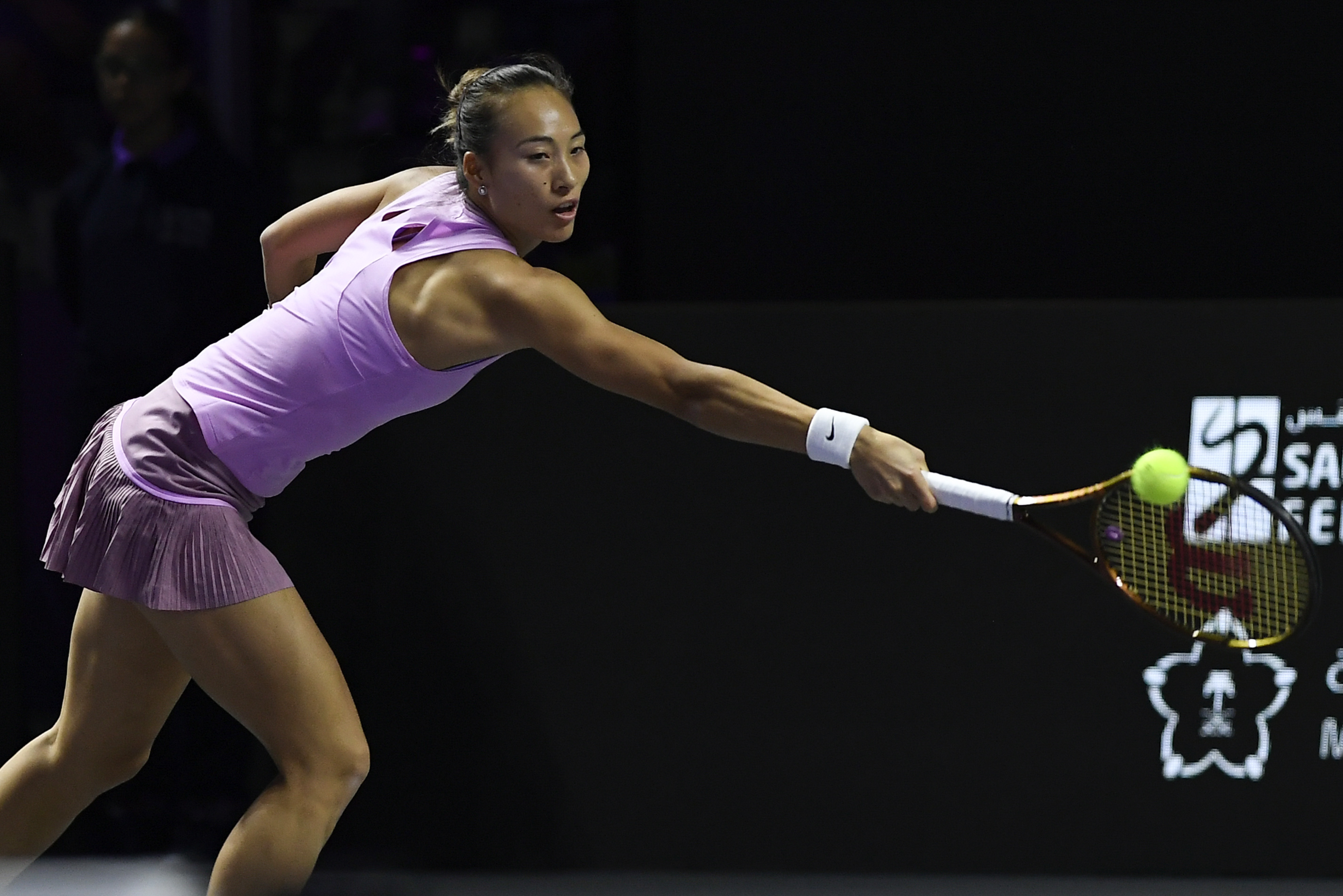 China's Qinwen Zheng returns the ball during her women's singles semifinal match against Czech Republic's Barbora Krejcikova at King Saud University Indoor Arena, in Riyadh, Saudi Arabia, Friday, Nov. 8, 2024. 