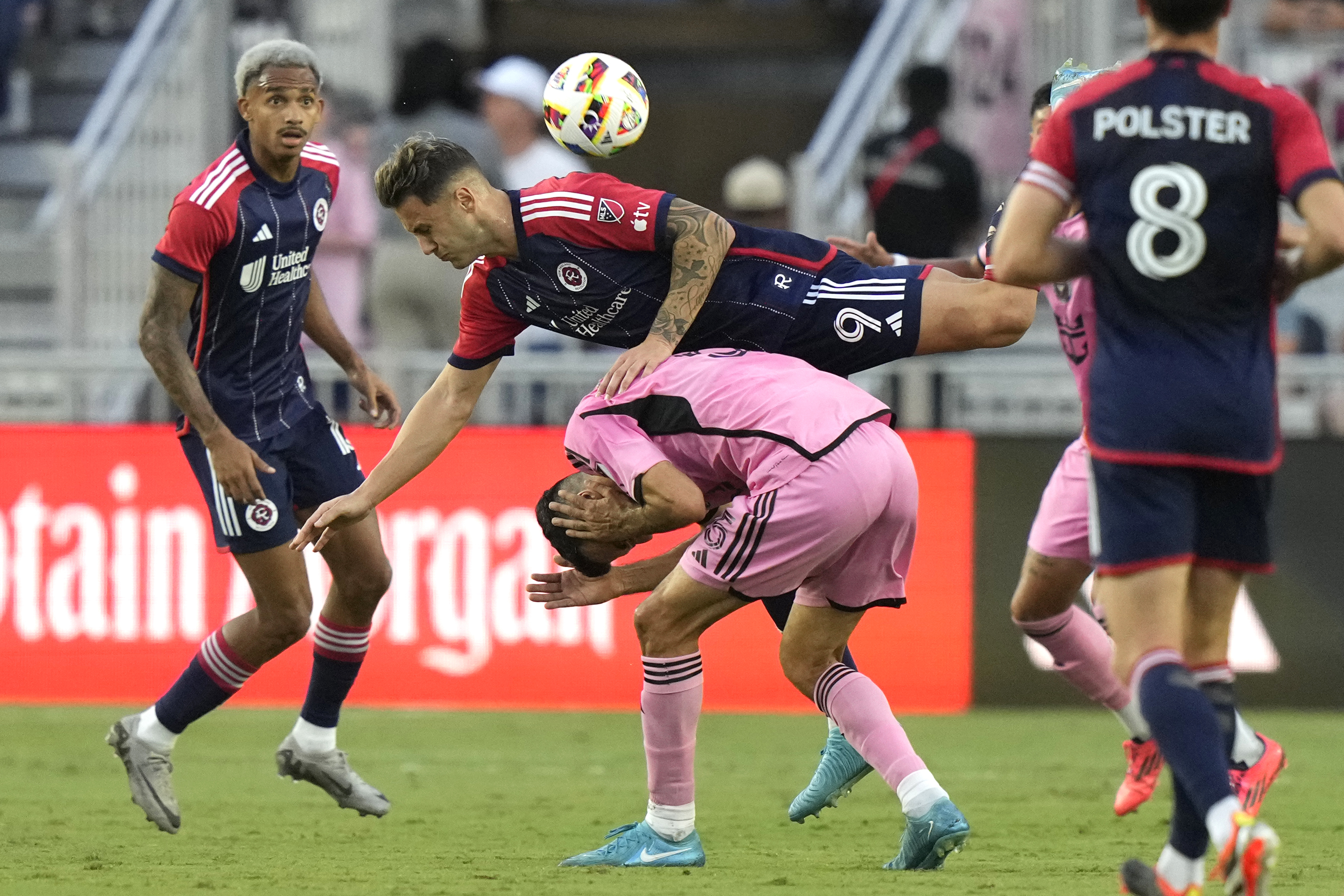 New England Revolution forward Giacomo Vrioni (9) goes for the ball over Inter Miami midfielder Sergio Busquets (5) during the first half of an MLS soccer match, Saturday, Oct. 19, 2024, in Fort Lauderdale, Fla.