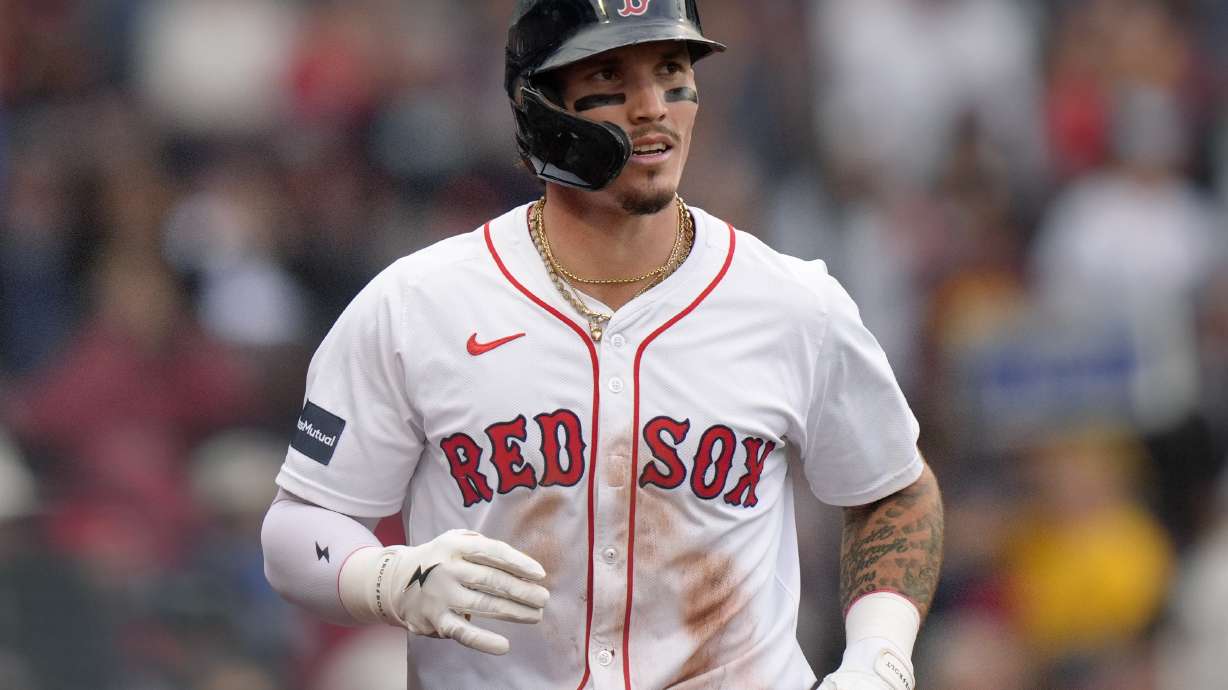 FILE - Boston Red Sox outfielder Jarren Duran, center, returns to the dugout after scoring on an error after Vaughn Grissom hit a double in the third inning of a baseball game against the Tampa Bay Rays, Sept. 29, 2024, in Boston.