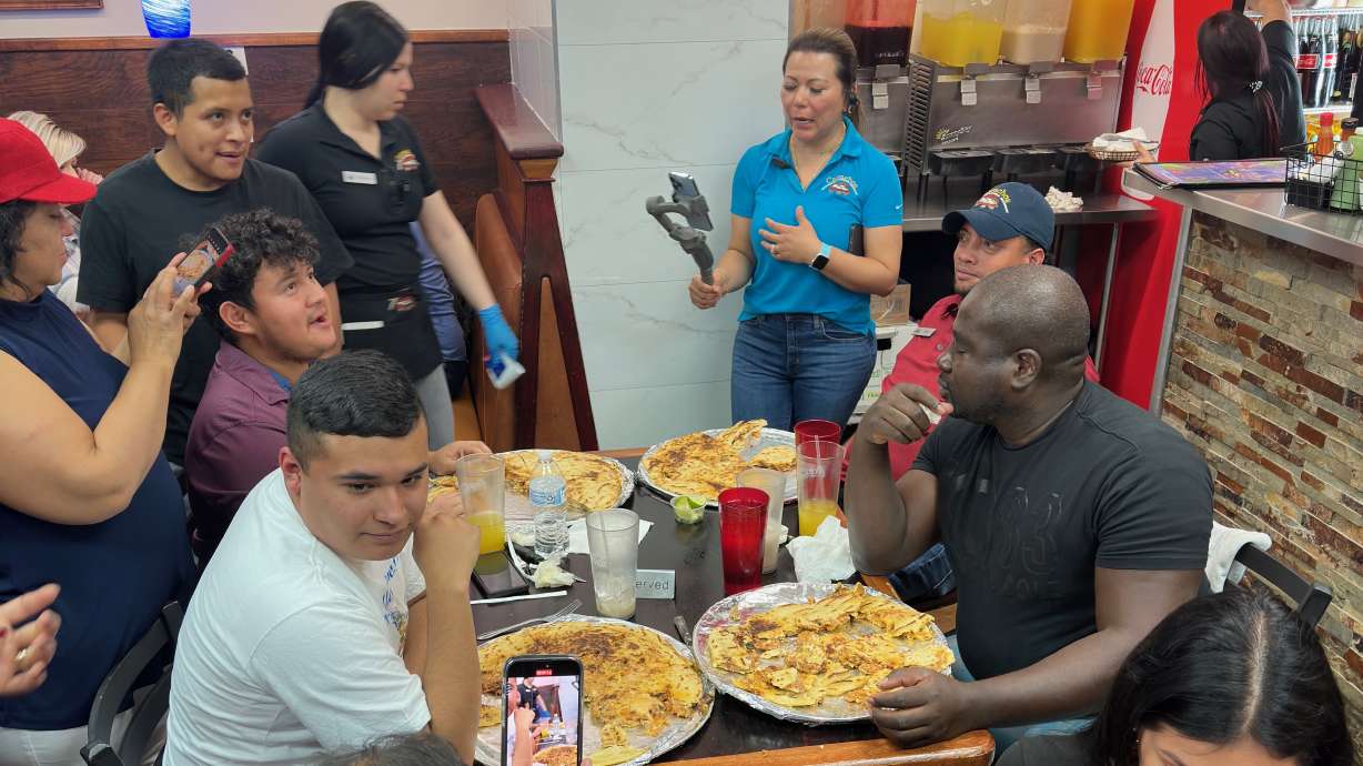 Utah's Salvadoran community is hosting International Pupusa Day activities on Saturday. In the photo, participants in activities in 2023 at a West Valley City restaurant eat pupusas.