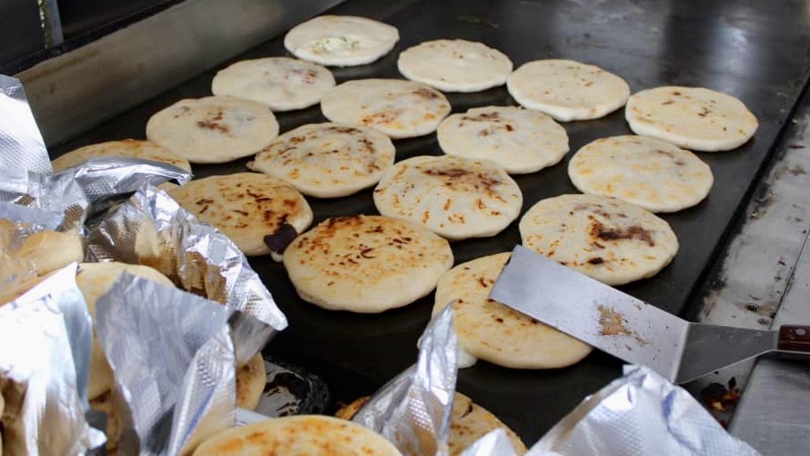 Pupusas cook on a grill at Pupuseria El Paraíso in this undated photo.