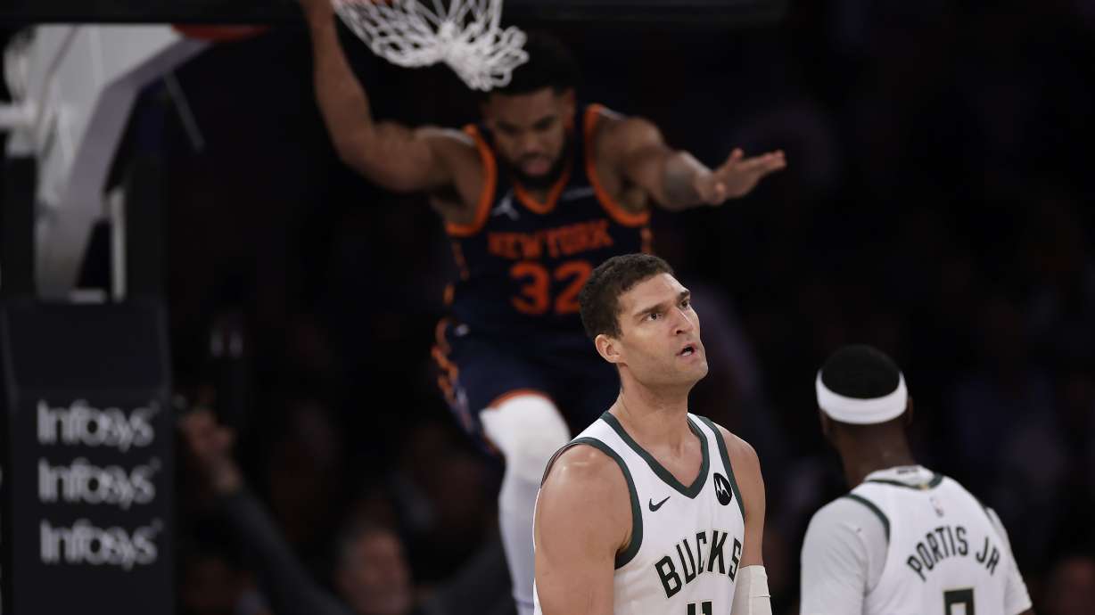 Milwaukee Bucks center Brook Lopez (11) reacts after New York Knicks center Karl-Anthony Towns (32) dunked during the first half of an NBA basketball game Friday, Nov. 8, 2024, in New York.