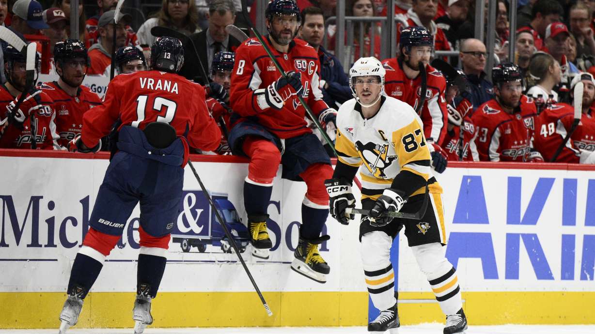 Pittsburgh Penguins center Sidney Crosby (87) skates by Washington Capitals left wings Alex Ovechkin (8) and Jakub Vrana (13) during the second period of an NHL hockey game, Friday, Nov. 8, 2024, in Washington.