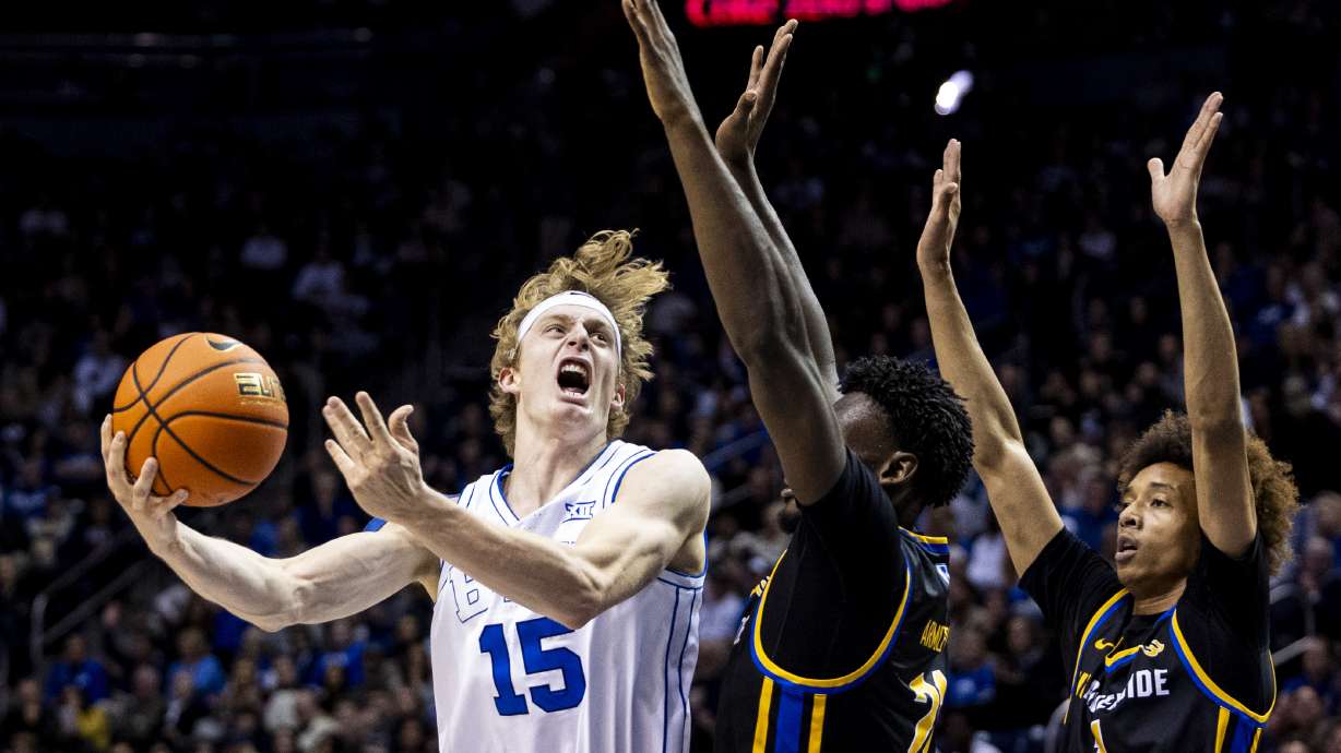 Brigham Young forward Richie Saunders (15) lays the ball up while guarded by UC Riverside center Joel Armotrading (21) during an NCAA men’s basketball game held at the Marriott Center on the campus of BYU in Provo on Friday, Nov. 8, 2024.