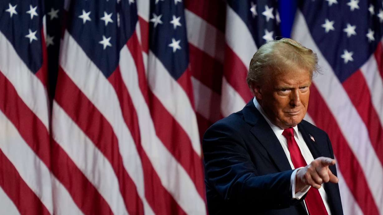 President-elect Donald Trump points to the crowd at an election night watch party, Wednesday, in West Palm Beach, Fla.
