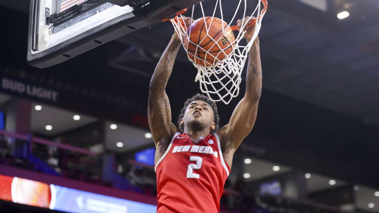 New Mexico guard Donovan Dent (2) dunks the ball during the first half of an NCAA basketball game against UCLA Friday, Nov. 8, 2024, in Henderson, Nev. against the New Mexico