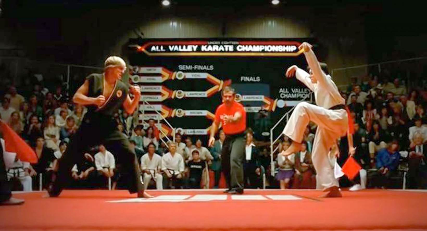 L to R: William Zabka as Johnny Lawrence, Pat E. Johnson as the referee, and Ralph Macchio as Daniel LaRusso in a scene from the 1984 film "The Karate Kid."