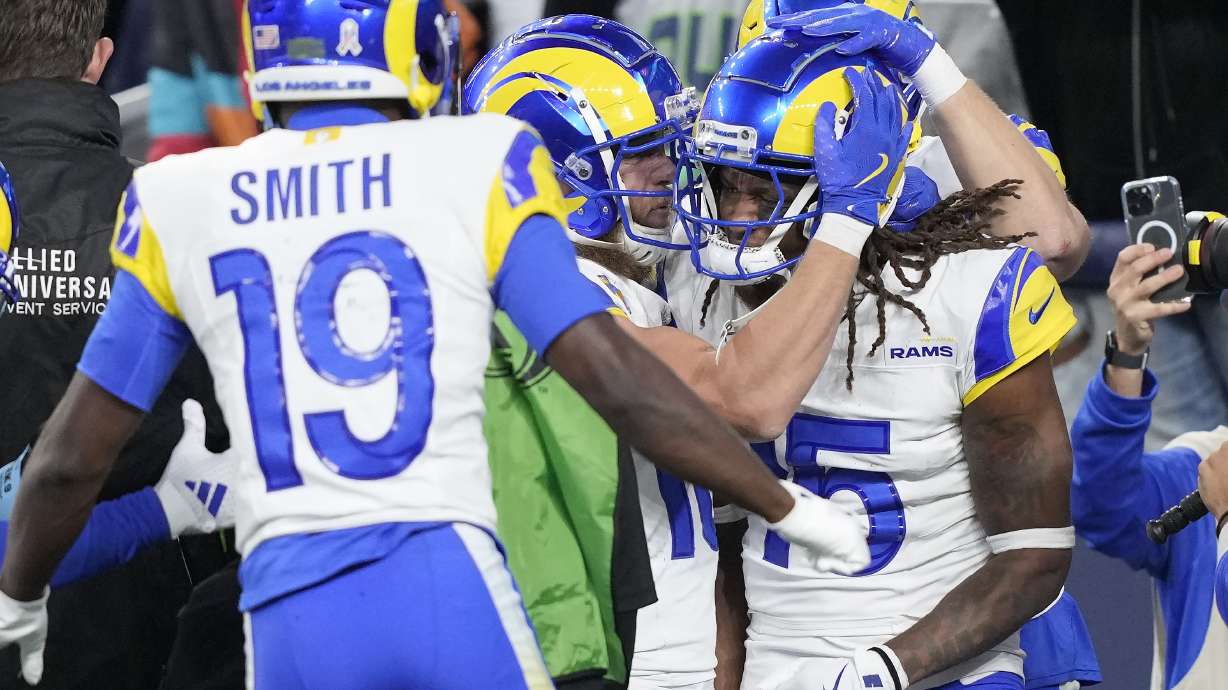 Los Angeles Rams wide receiver Demarcus Robinson, right, is congratulated by Xavier Smith (19) and Cooper Kupp, middle, after catching a touchdown pass during overtime of an NFL football game against the Seattle Seahawks in Seattle, Sunday, Nov. 3, 2024.