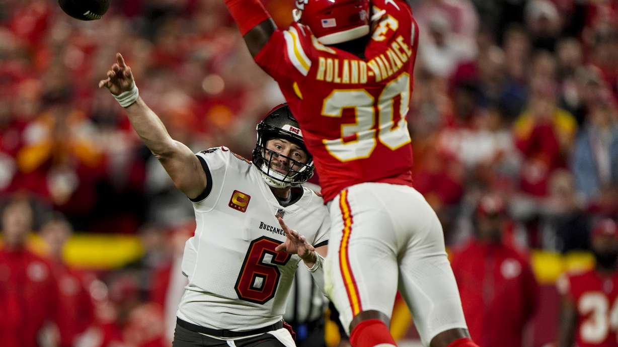 Tampa Bay Buccaneers quarterback Baker Mayfield (6) passes under pressure by Kansas City Chiefs cornerback Christian Roland-Wallace (30) during the first half of an NFL football game, Monday, Nov. 4, 2024, in Kansas City, Mo.