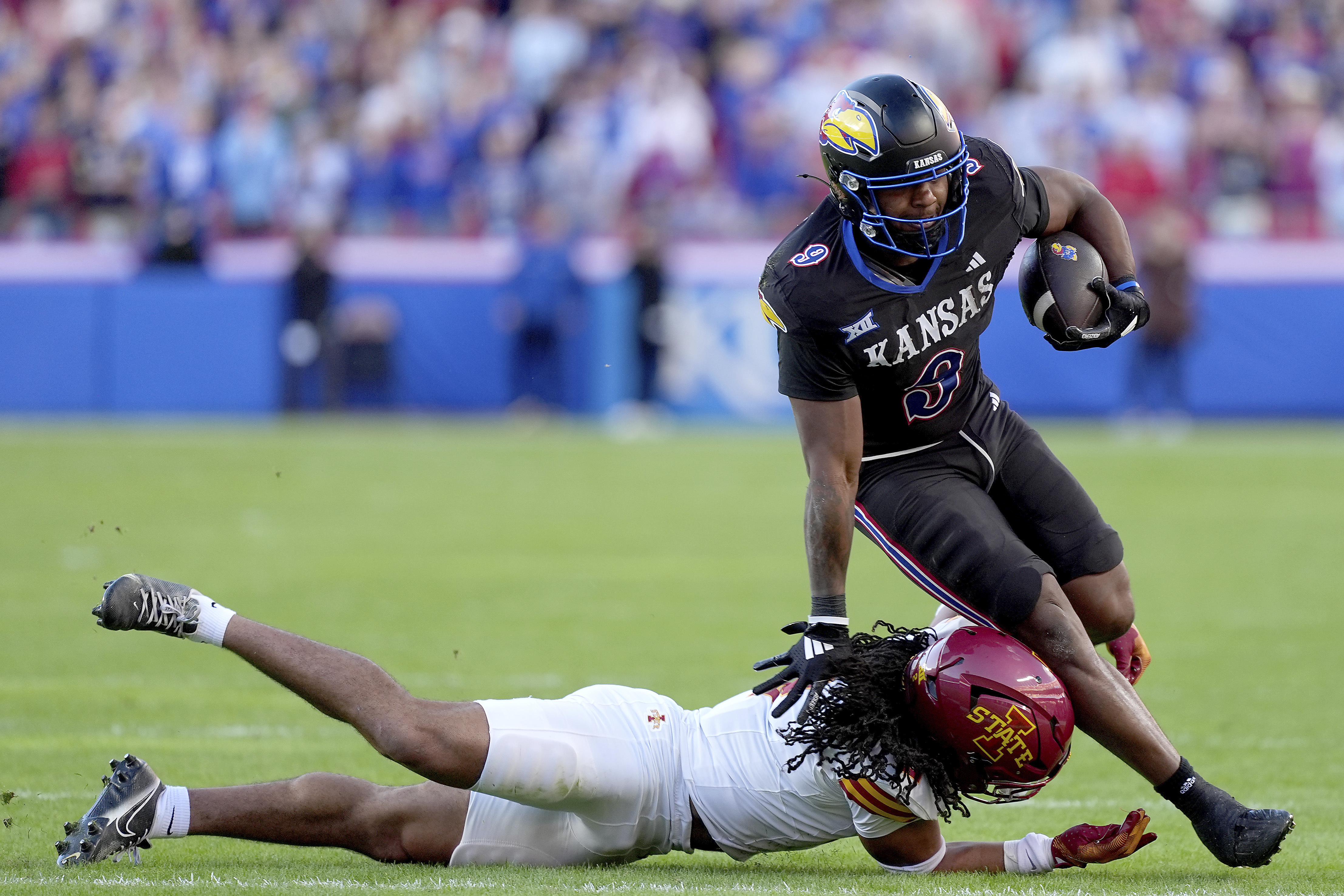 Kansas running back Daniel Hishaw Jr. (9) is tackled by Iowa State defensive back Jamison Patton (2) during the first half of an NCAA college football game Saturday, Nov. 9, 2024, in Kansas City, Mo.