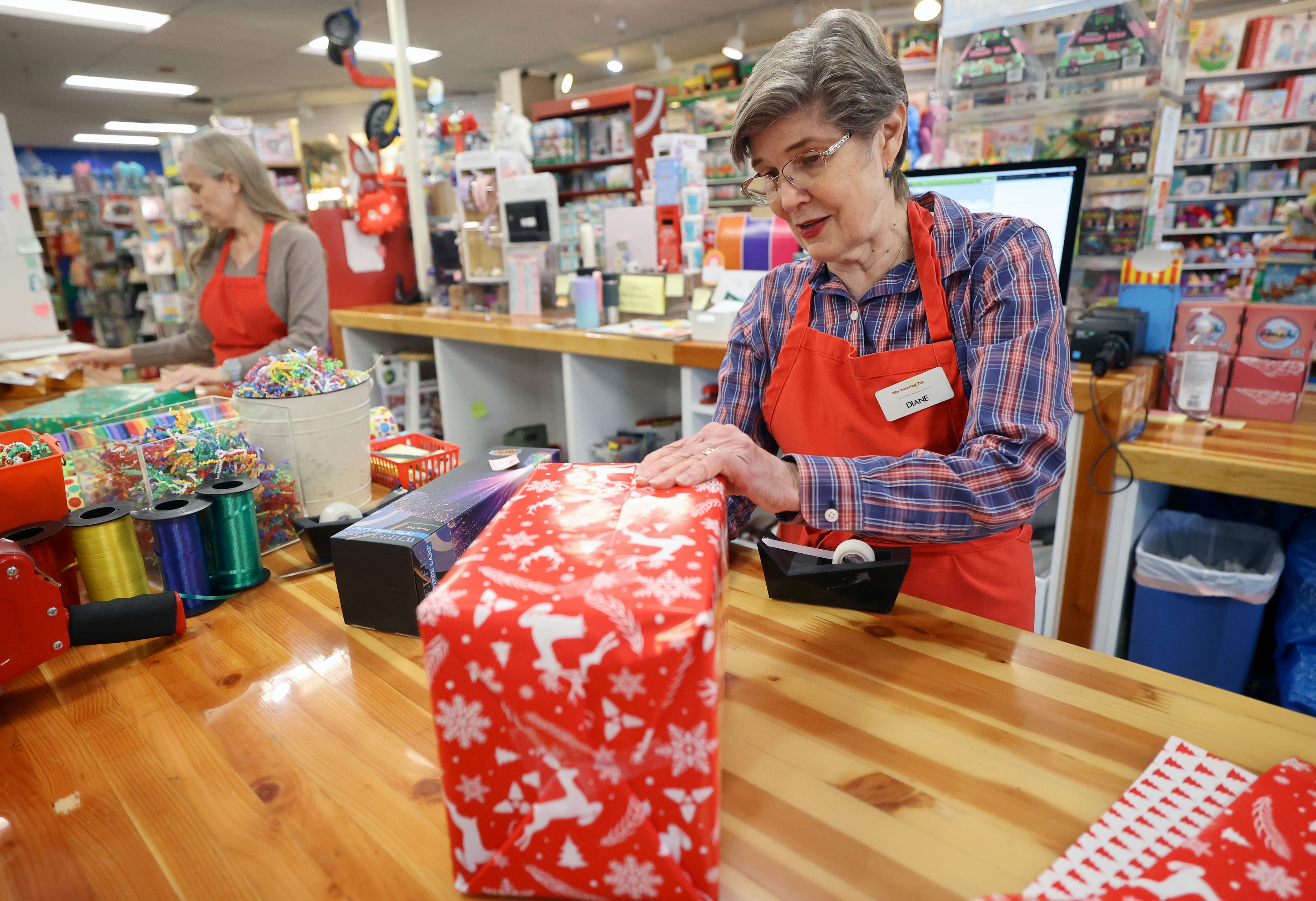 Diane Sartain, Tutoring Toy co-owner, wraps a present for a customer doing early holiday shopping at Tutoring Toy in Salt Lake City on Nov. 7.