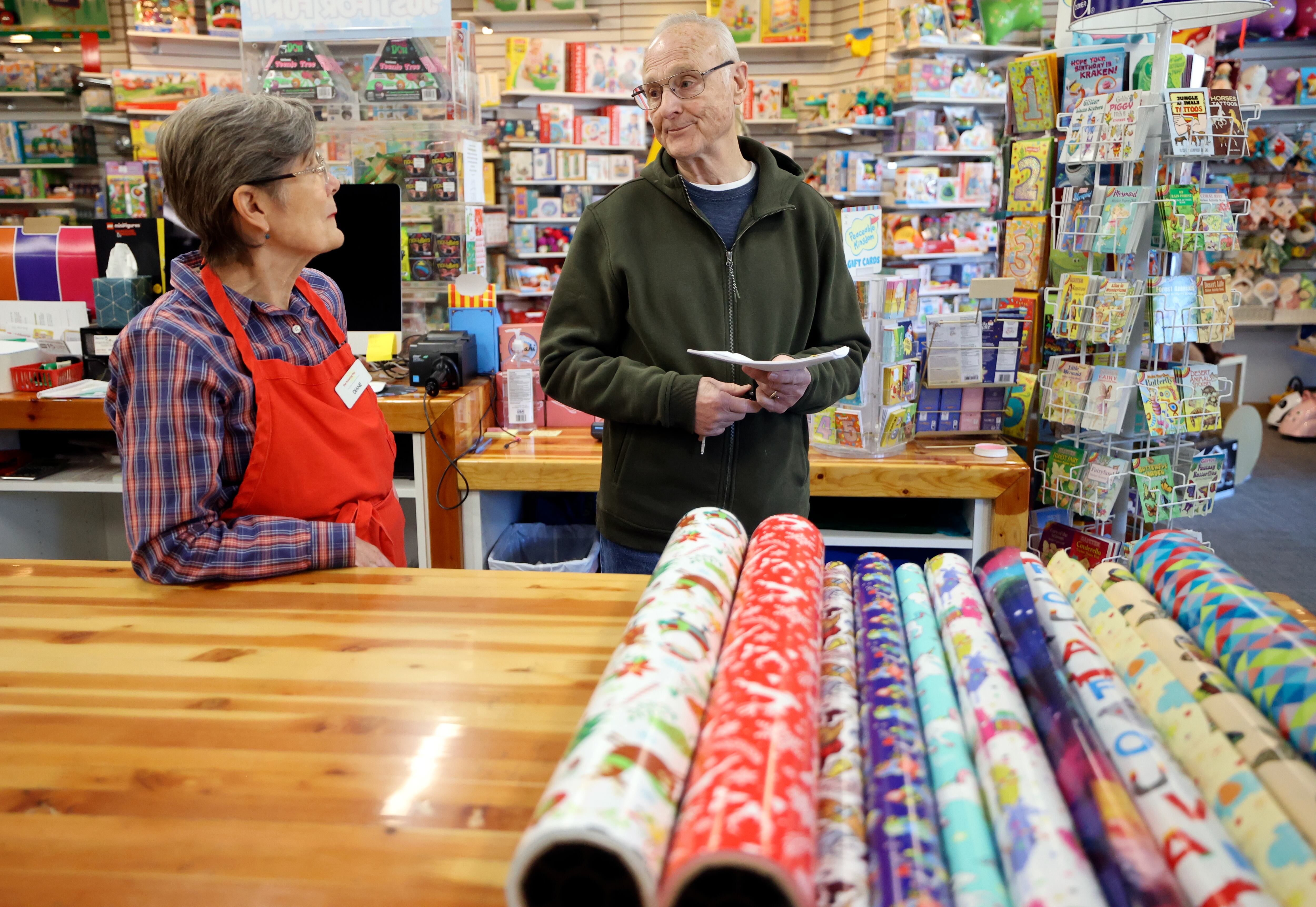 Tutoring Toy co-owners Diane Sartain and Bill Sartain chat while working at Tutoring Toy in Salt Lake City on Nov. 7.