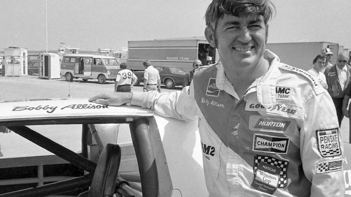 FILE - Bobby Allison stands beside his car and talks with the press after winning the pole position during qualifying for the 500 mile grand national stock car race at Pocono Raceway, Aug. 2, 1975, in Long Pond, Pa.