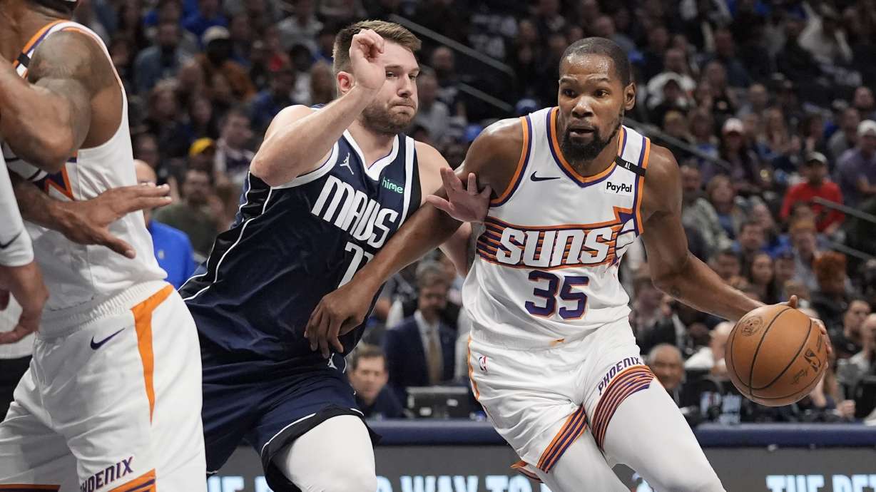 Phoenix Suns forward Kevin Durant (35) drives against Dallas Mavericks guard Luka Doncic (77) during the first half of an NBA basketball game Friday, Nov. 8, 2024, in Dallas.