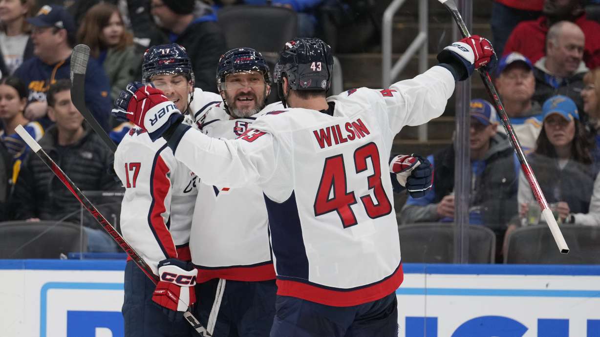 Washington Capitals' Alex Ovechkin, center, is congratulated by teammates Dylan Strome and Tom Wilson (43) after scoring during the third period of an NHL hockey game against the St. Louis Blues Saturday, Nov. 9, 2024, in St. Louis.