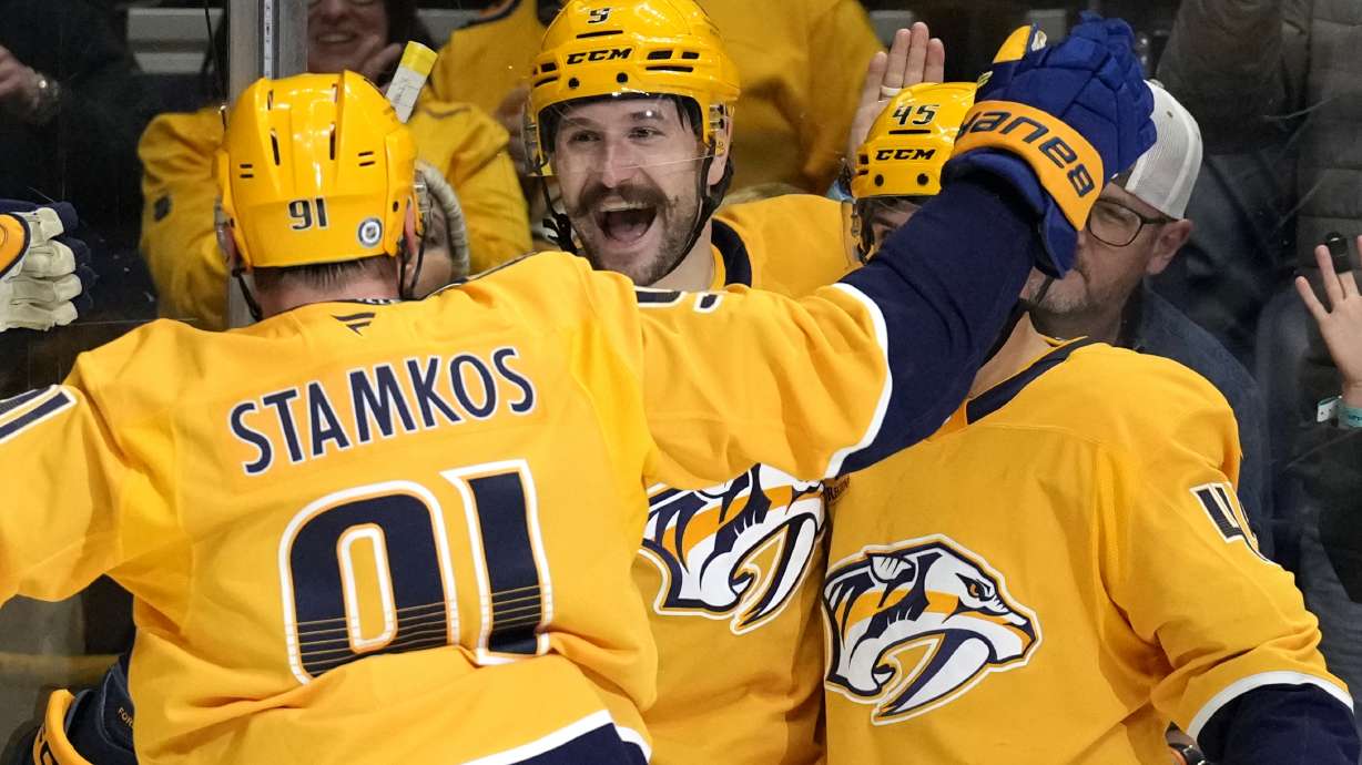 Nashville Predators left wing Filip Forsberg, center, celebrates his second goal of the game with Steven Stamkos (91) during the second period of an NHL hockey game against the Utah Hockey Club Saturday, Nov. 9, 2024, in Nashville, Tenn.