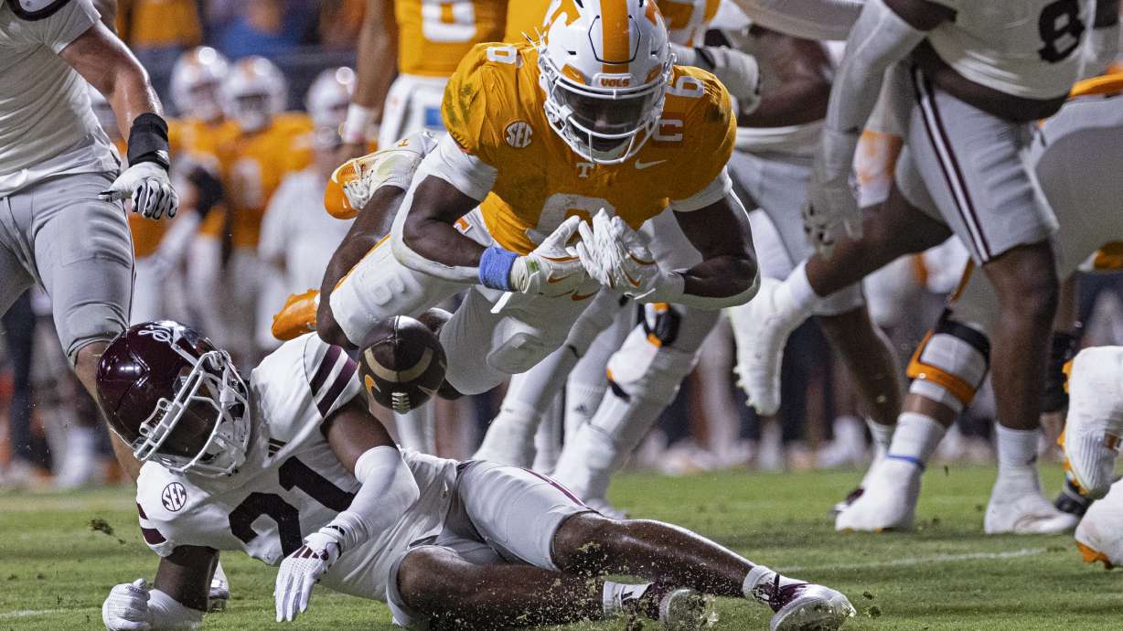 Tennessee running back Dylan Sampson (6) fumbles the ball as he's hit by Mississippi State safety Hunter Washington (21) during the first half of an NCAA college football game Saturday, Nov. 9, 2024, in Knoxville, Tenn.