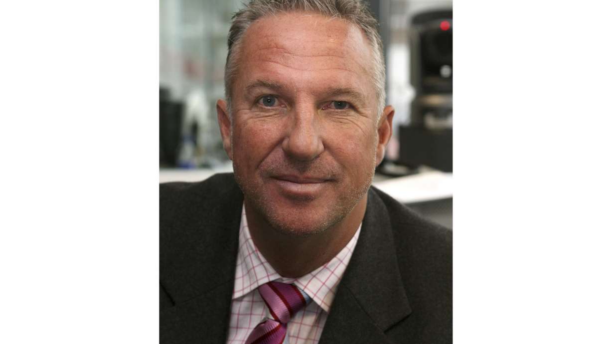 FILE - Former England cricketer Ian Botham prepares to commentate on the first day of England's fourth Test match of their four Test series against the West Indies in Durham, England on June 15, 2007
