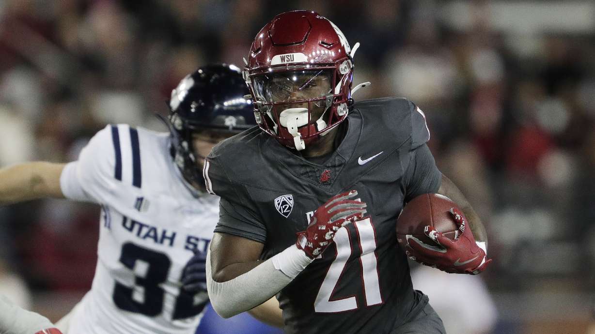 Washington State running back Wayshawn Parker (21) carries the ball during the first half of an NCAA college football game against Utah State, Saturday, Nov. 9, 2024, in Pullman, Wash.