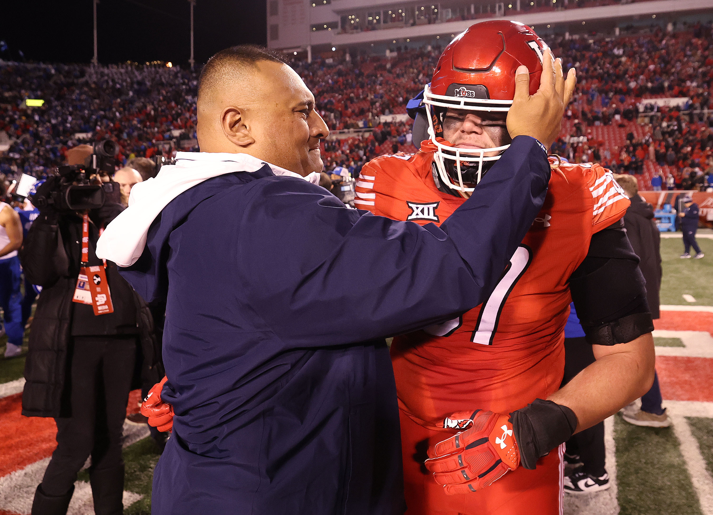 Brigham Young head coach Kalani Sitake talks with Utah defensive tackle Keanu Tanuvasa (57) after the game at Rice-Eccles Stadium in Salt Lake City on Sunday, Nov. 10, 2024. BYU won 22-21.