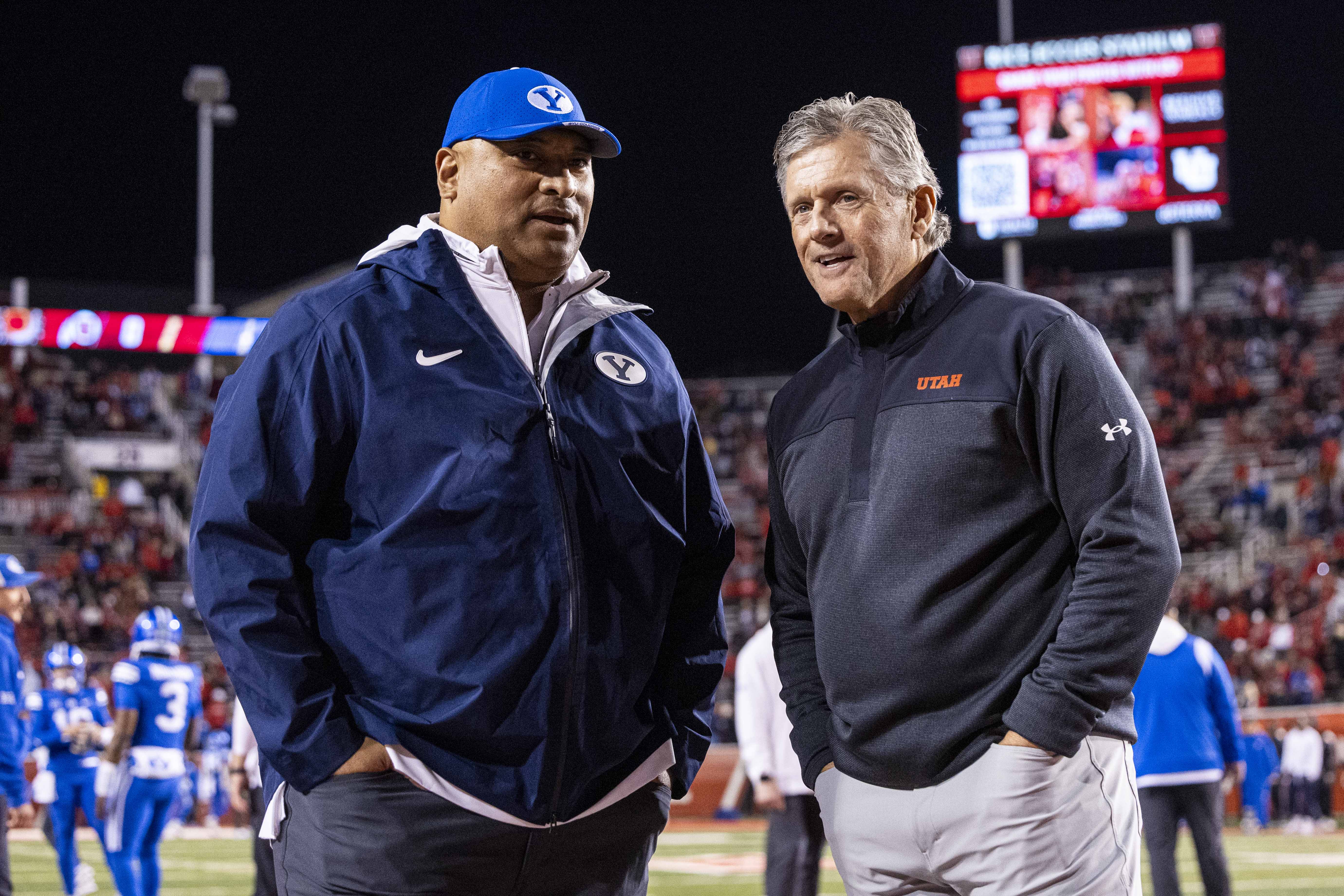 BYU football head coach Kalani Sitake and Utah Utes football head coach Kyle Whittingham talk before a game between the University of Utah Utes and the BYU Cougars held at Rice-Eccles Stadium in Salt Lake City on Saturday, Nov. 9, 2024.