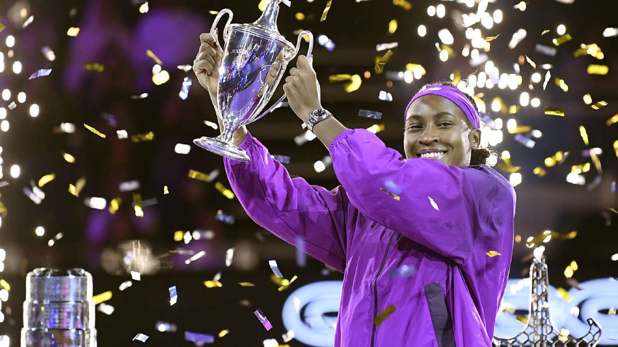Coco Gauff of the U.S. holds her trophy after winning against China's Qinwen Zheng in their women's singles final match of the WTA finals at the King Saud University Indoor Arena, in Riyadh, Saudi Arabia, Saturday, Nov. 9, 2024.