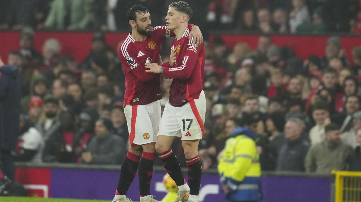 Manchester United's Alejandro Garnacho , right, celebrates with his teammate Bruno Fernandes after scoring his side's third goal during the English Premier League soccer match between Manchester United and Leicester City, at the Old Trafford stadium in Manchester, England, Sunday, Nov.10, 2024.