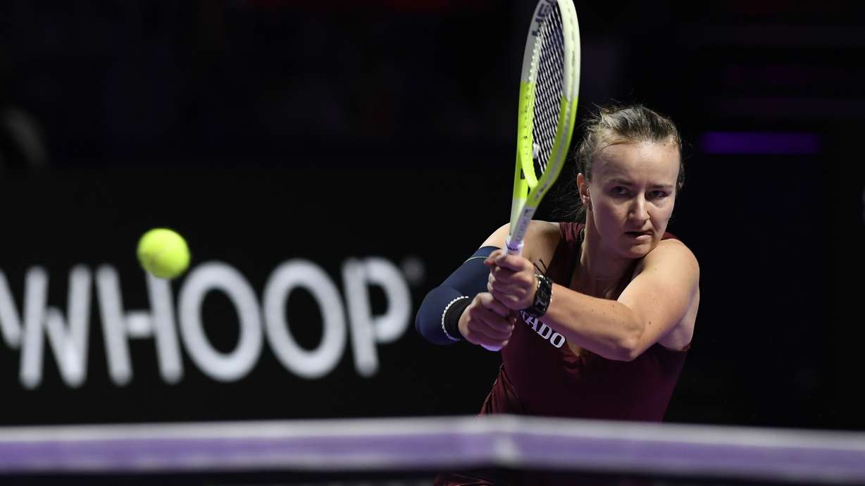 Czech Republic's Barbora Krejcikova, in action with China's Qinwen Zheng during women's singles semi final match at King Saud University Indoor Arena, in Riyadh, Saudi Arabia, Friday, Nov. 8, 2024.