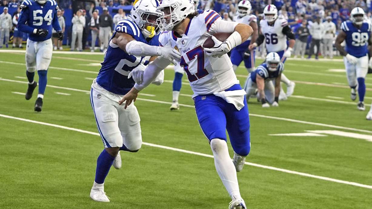 Buffalo Bills quarterback Josh Allen (17) runs for a touchdown with Indianapolis Colts safety Nick Cross (20) defending during the first half of an NFL football game, Sunday, Nov. 10, 2024, in Indianapolis.