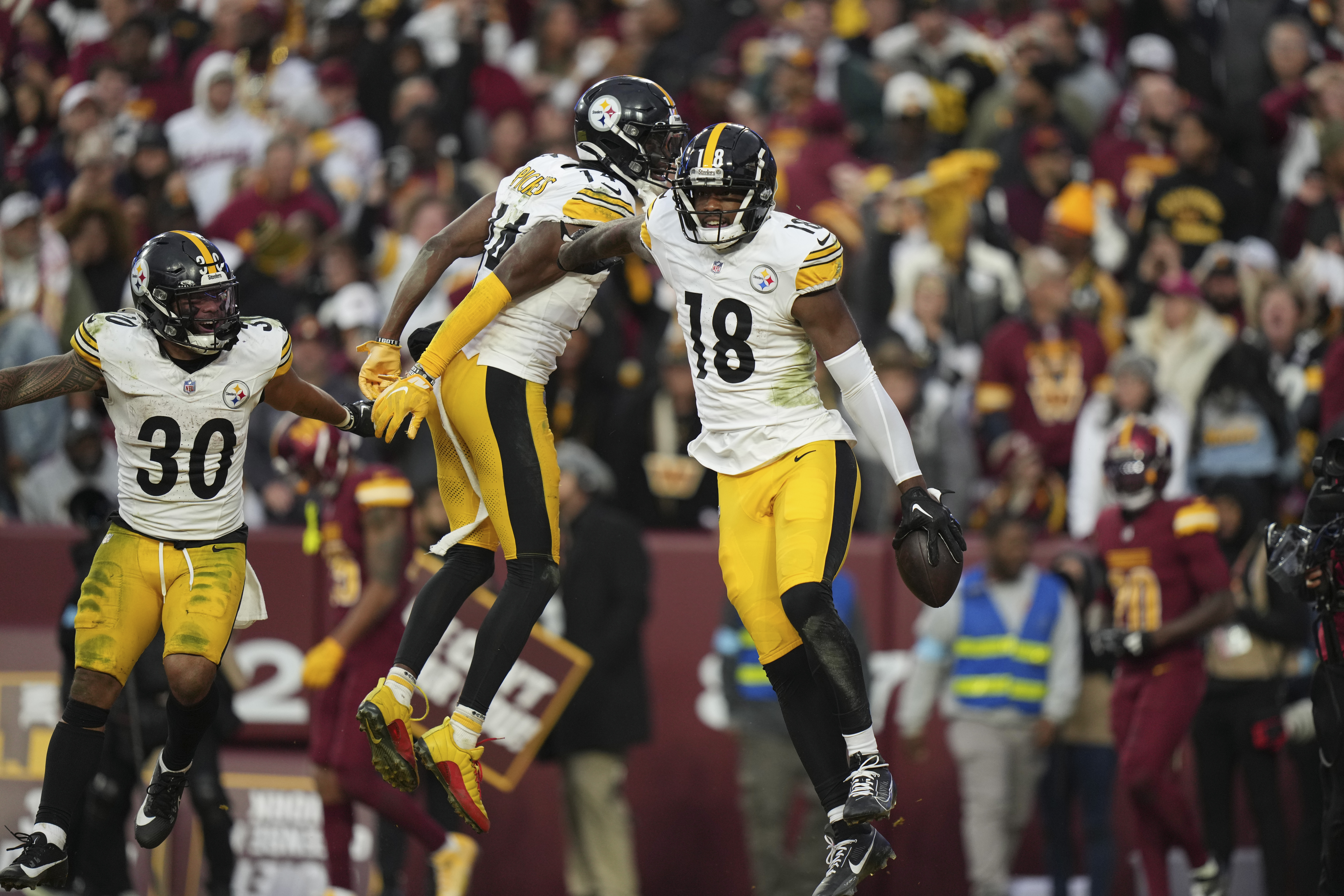Pittsburgh Steelers wide receiver Mike Williams (18) celebrates his 32-yard touchdown reception with teammate wide receiver George Pickens (14) during the second half of an NFL football game against the Washington Commanders, Sunday, Nov. 10, 2024, in Landover, Md.