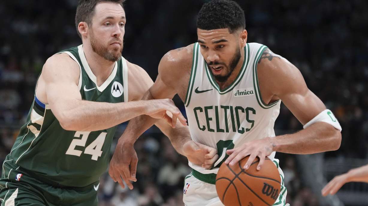 Boston Celtics' Jayson Tatum tries to get past Milwaukee Bucks' Pat Connaughton during the first half of an NBA basketball game Sunday, Nov. 10, 2024, in Milwaukee.