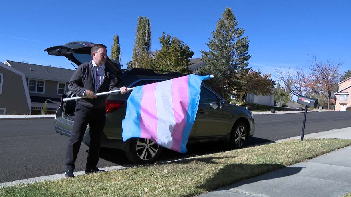 Daren Haws has been volunteering for the past two to three years with the nonprofit Project Rainbow. Here he is distributing flags in Salt Lake City on Sunday.