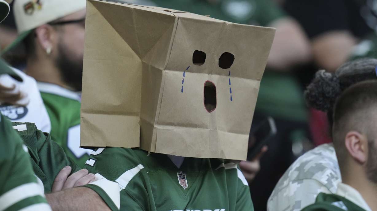 A New York Jets fan watches during the second half of an NFL football game against the Arizona Cardinals, Sunday, Nov. 10, 2024, in Glendale, Ariz.