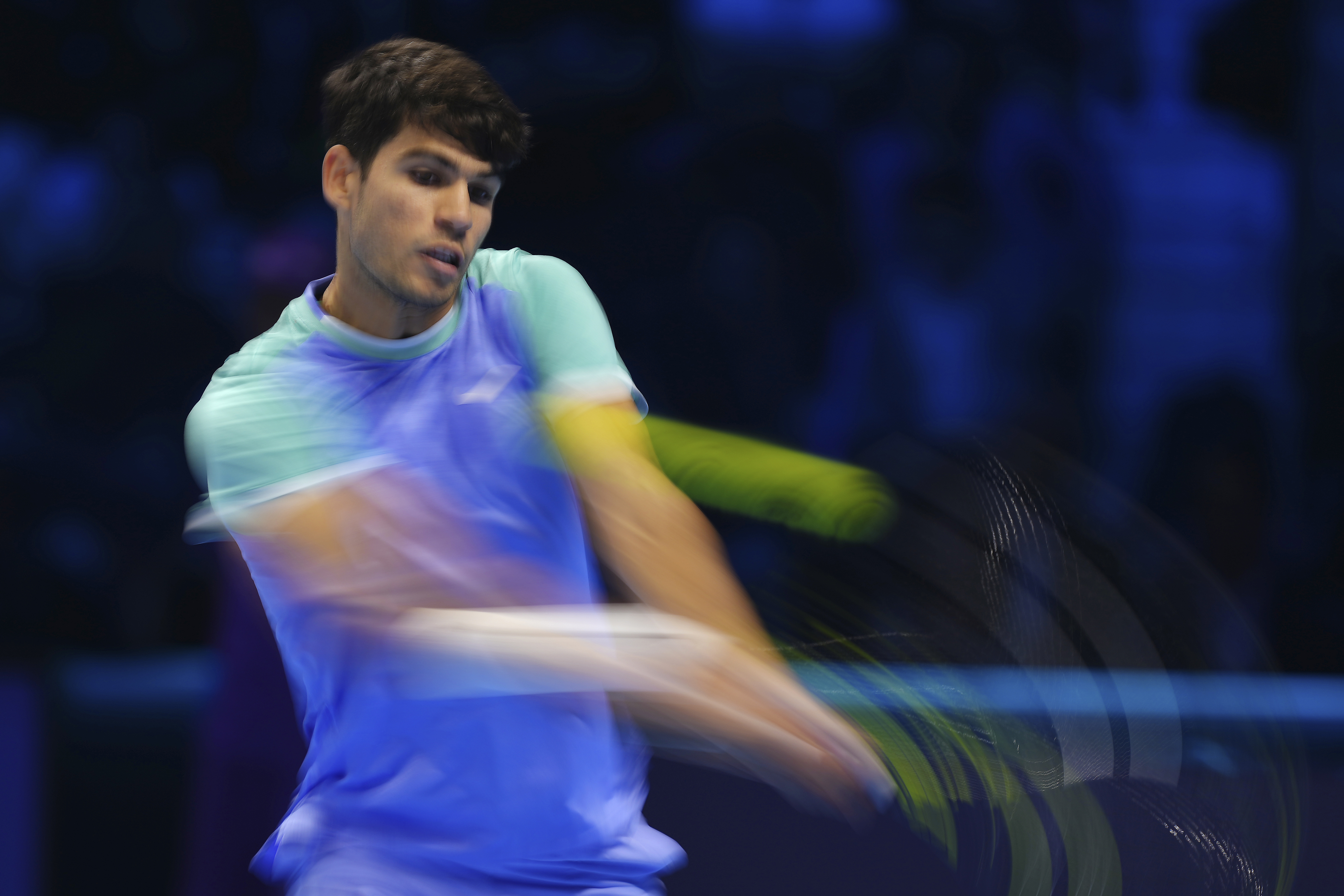 Spain's Carlos Alcaraz returns the ball to Denmark's Casper Ruud during their singles tennis match of the ATP World Tour Finals at the Inalpi Arena, in Turin, Italy, Monday, Nov. 11, 2024.