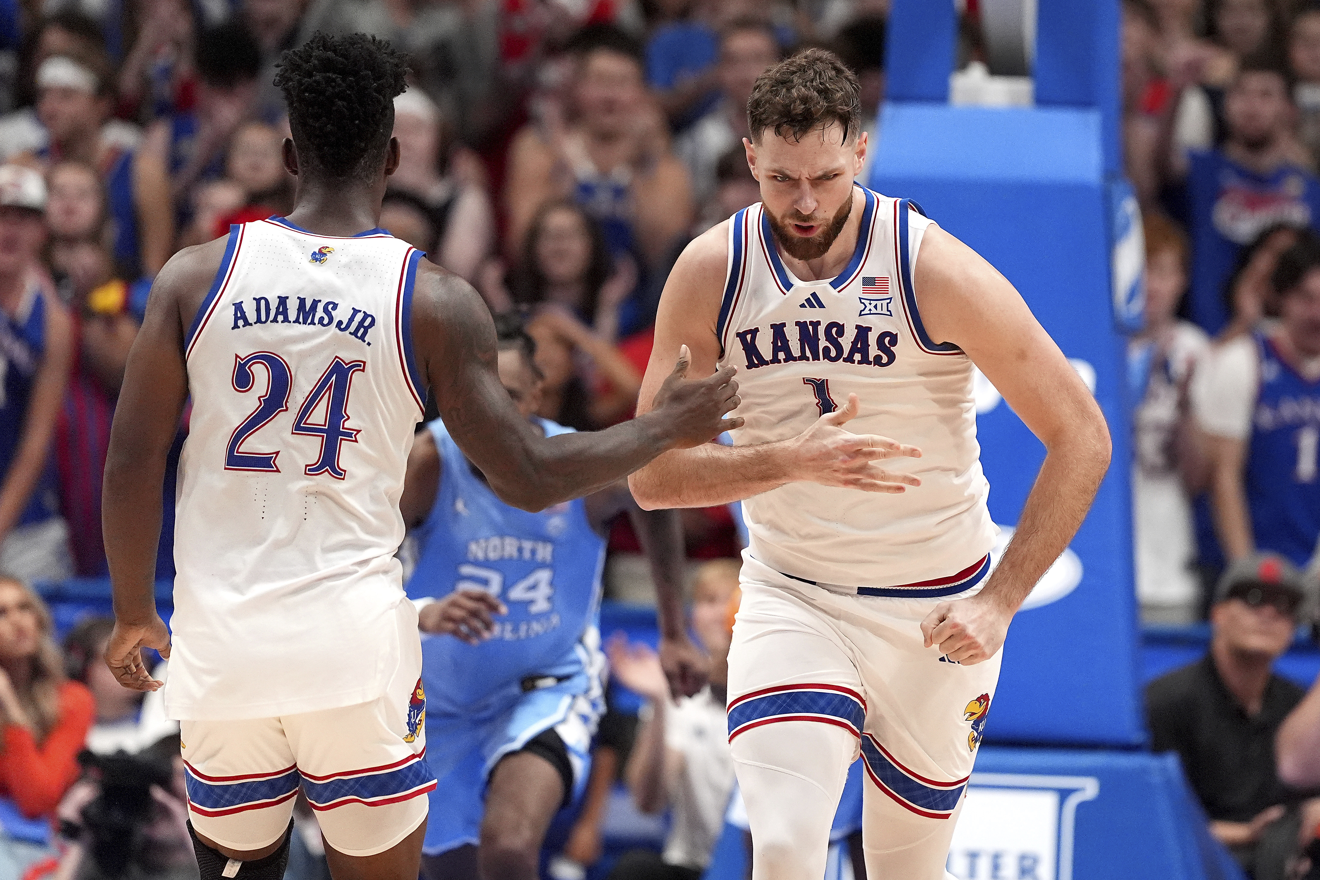 Kansas center Hunter Dickinson (1) celebrates with forward KJ Adams Jr. (24) after making a basket during the second half of an NCAA college basketball game against North Carolina Friday, Nov. 8, 2024, in Lawrence, Kan. Kansas won 92-89.