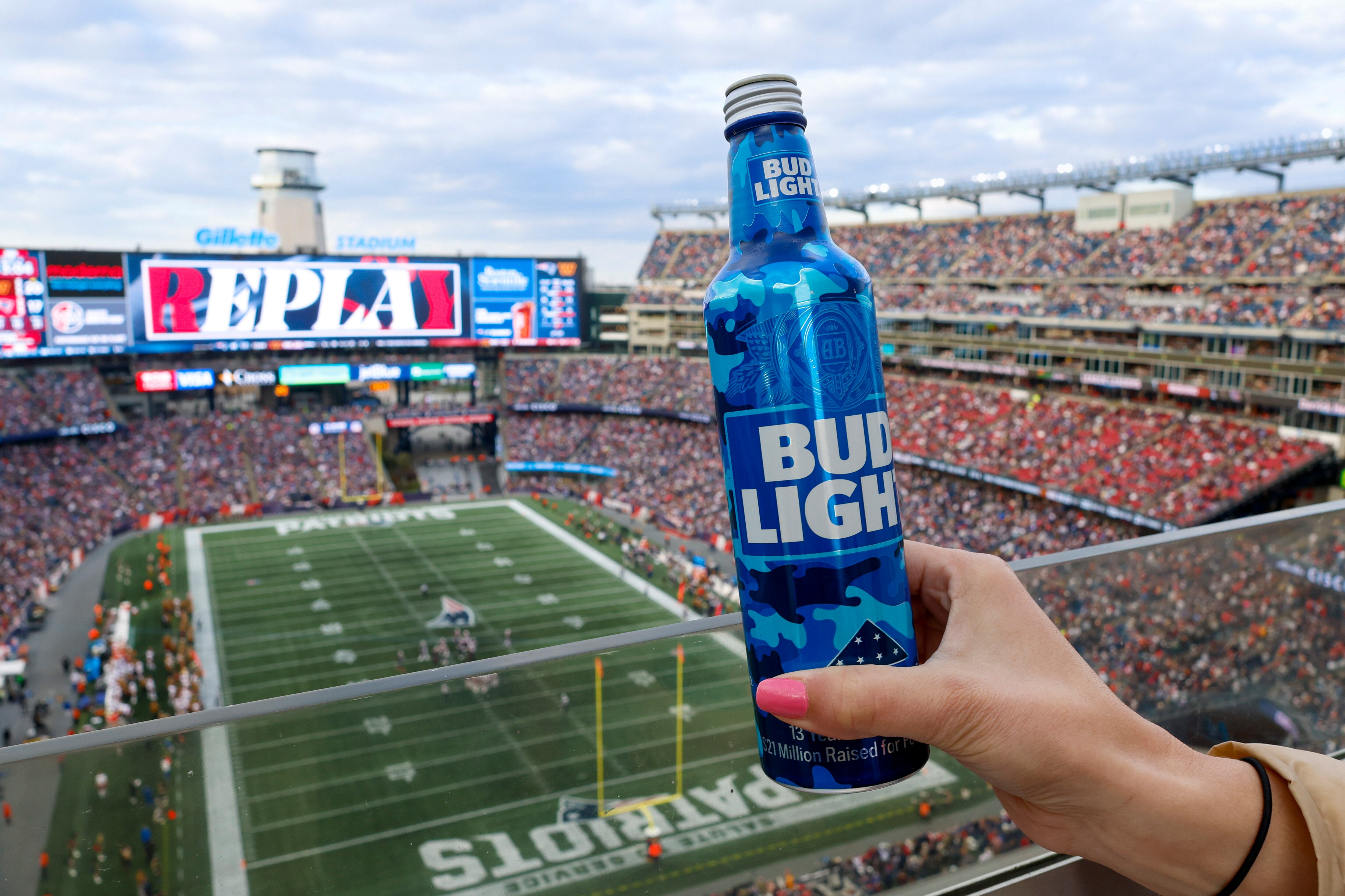 A New England Patriots fan holds a Bud Light during the second half of an NFL football game against the Washington Commanders on Nov. 5, 2023, in Foxborough, Mass.