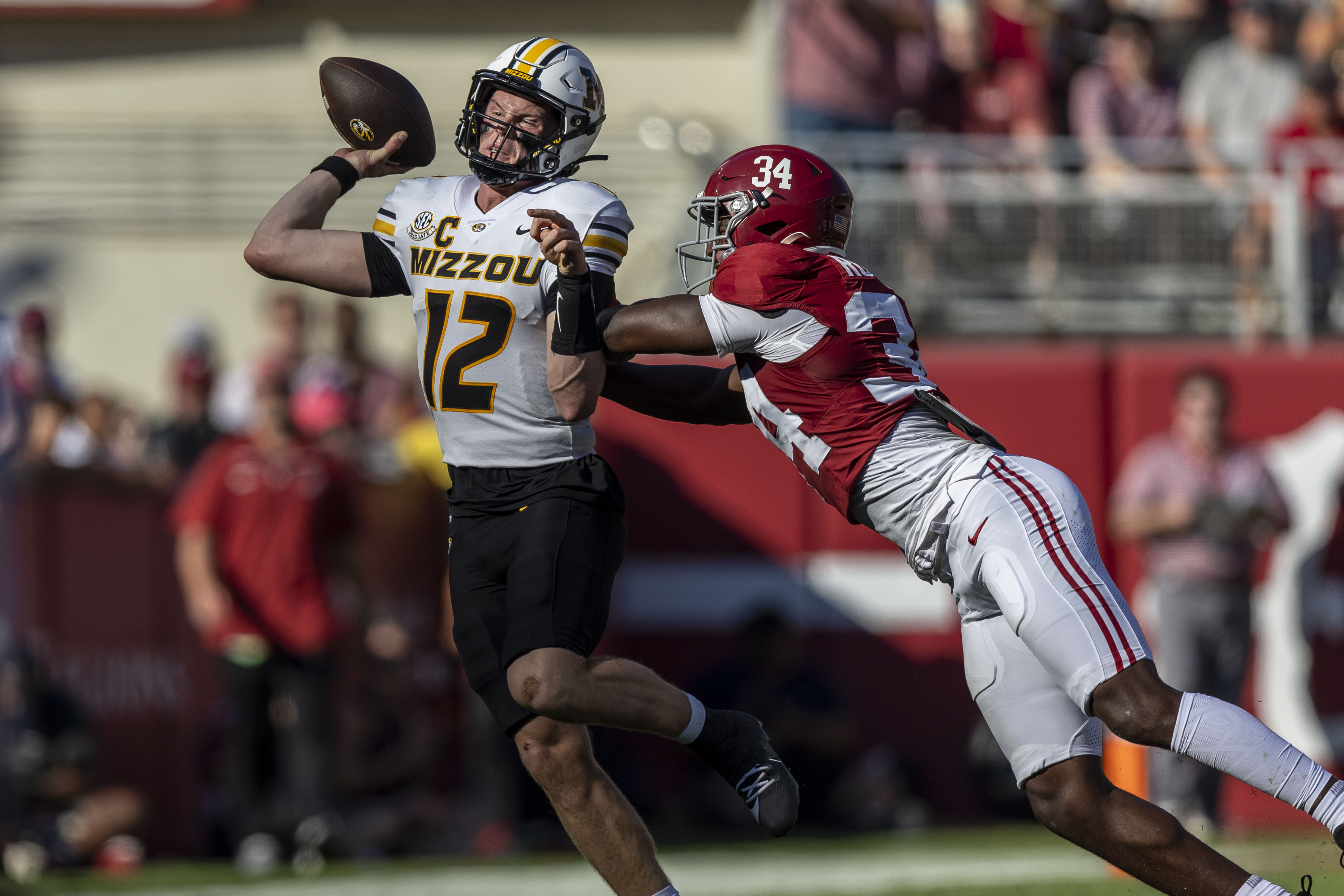 Missouri quarterback Brady Cook (12) is hit by Alabama linebacker Que Robinson (34) during the first half of an NCAA college football game, Saturday, Oct. 26, 2024, in Tuscaloosa, Ala. 