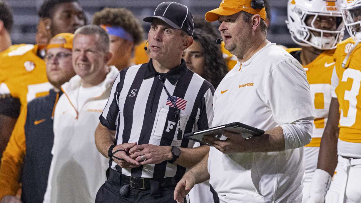 Tennessee head coach Josh Heupel talks with field judge Phillip Davenport during the second half of an NCAA college football game against Mississippi State, Saturday, Nov. 9, 2024, in Knoxville, Tenn.