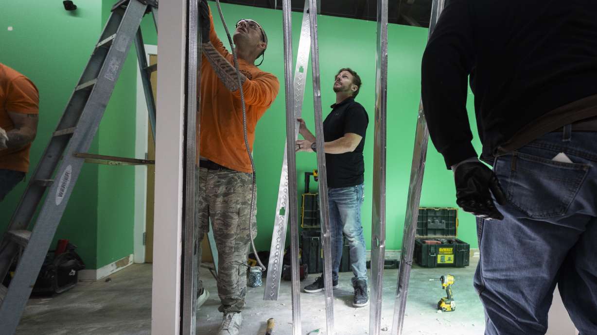 Students from the Other Side Academy work on an expansion at Salt Lake Valley Habitat for Humanity’s office in Salt Lake City on Monday. The agency is also expanding its services to cover Davis County along with Salt Lake and Tooele counties.