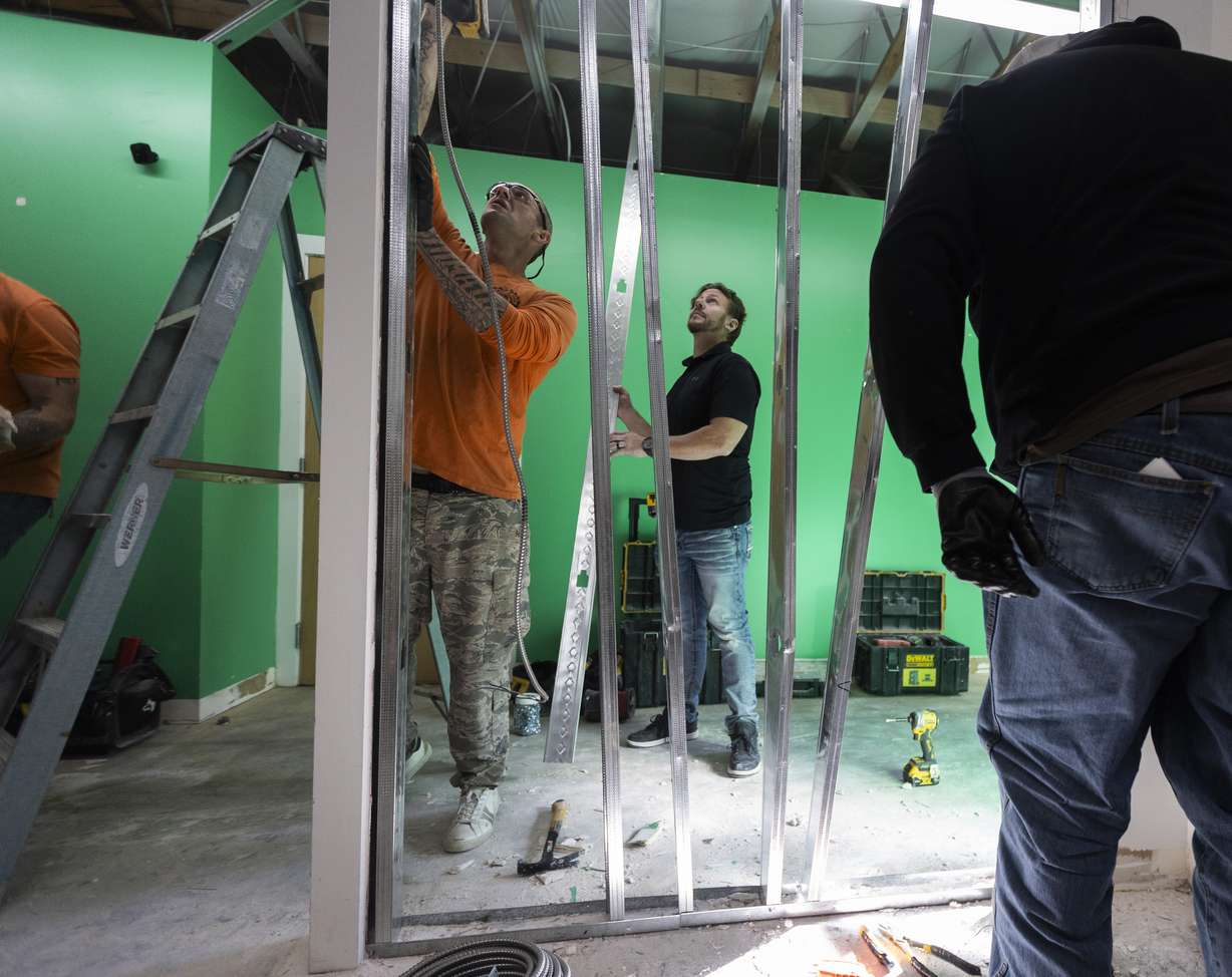 Students from the Other Side Academy work on building a expansion for Habitat for Humanity’s office in Salt Lake City on Monday.