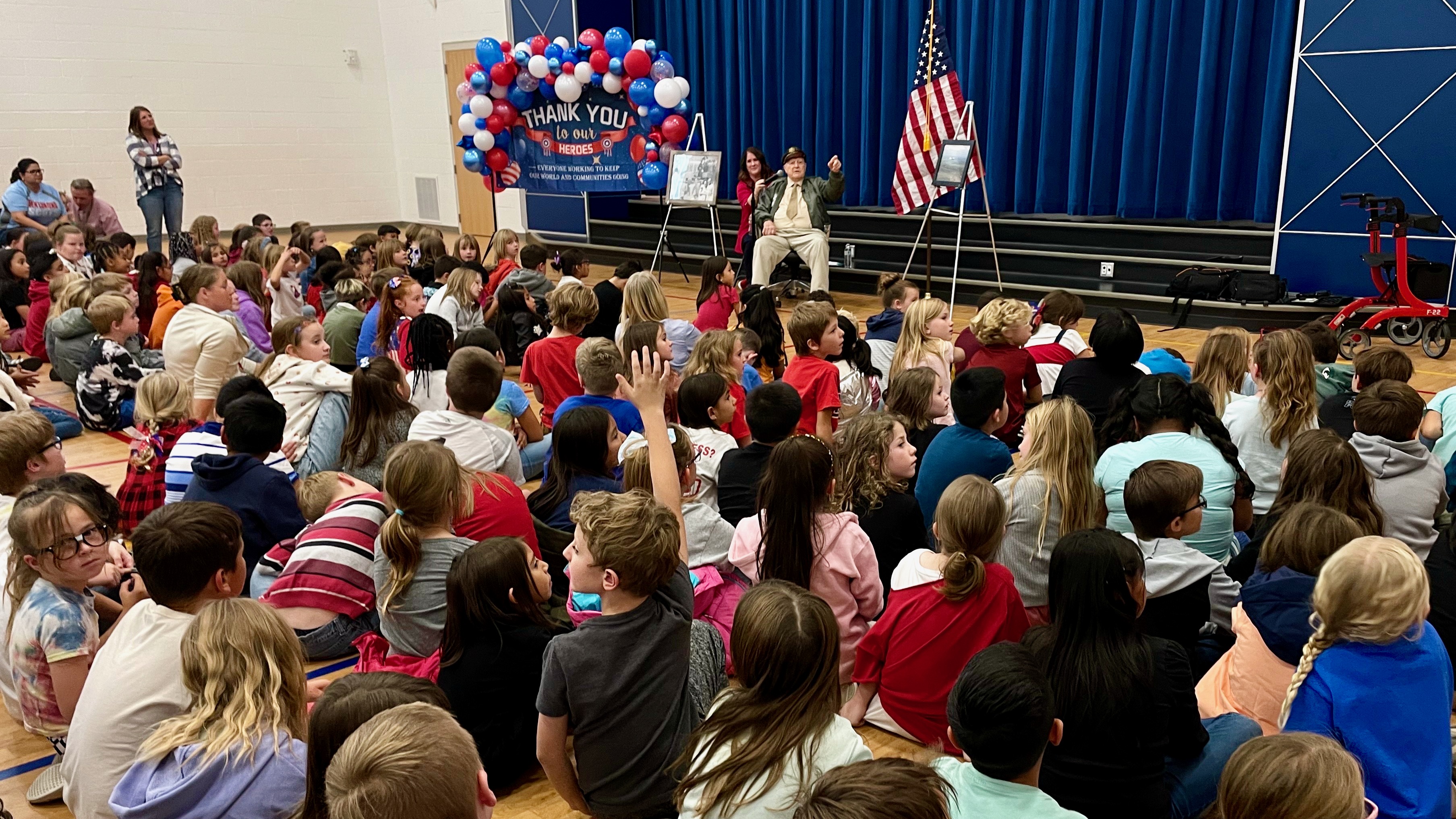 Ray Hobbs, a 100-year-old World War II veteran, addressed students at East Ridge Elementary in Ogden on Monday, Veterans Day.