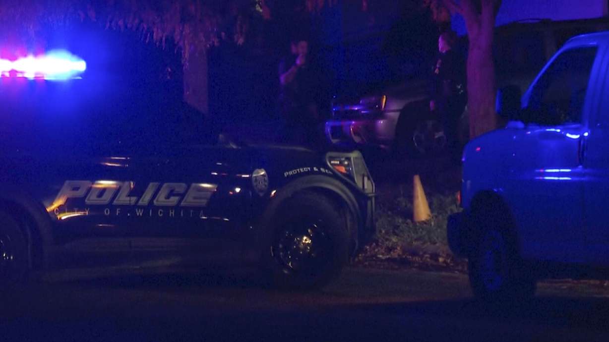 Police officers responded after multiple men were found shot to death inside several homes in the same area of Wichita, Kansas, Sunday.