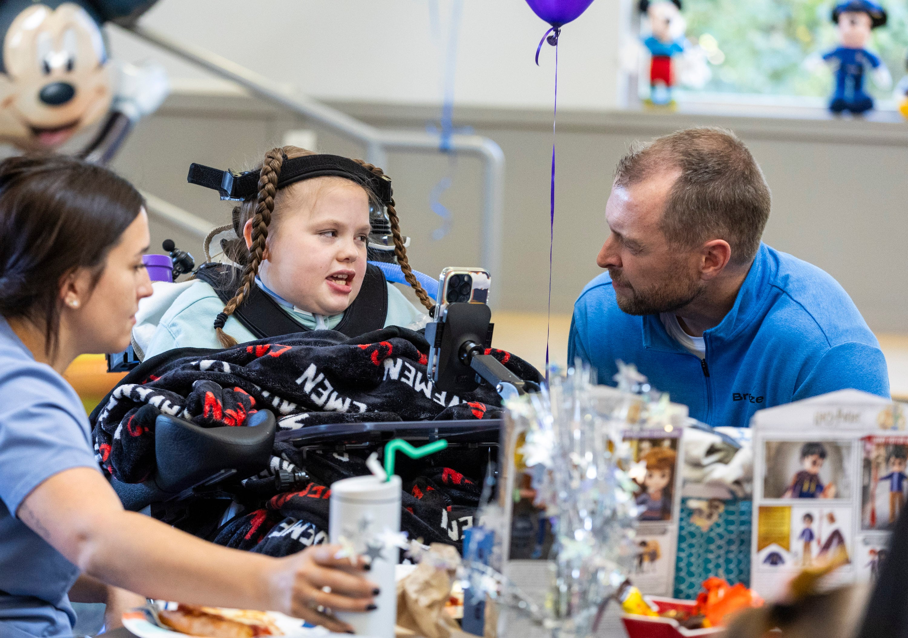 Sophia Ostler talks with Breeze chief financial officer, Trent Porter, during a proclamation celebration announcing that her wish has been selected for fulfillment at the Make-A-Wish Utah Headquarters in Murray on Monday.