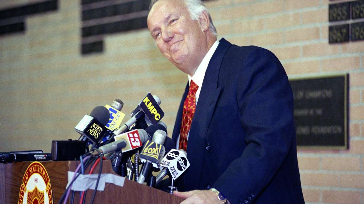 FILE - Former head coach of the Los Angeles Rams John Robinson addresses the media in Los Angeles, Jan. 3, 1992.