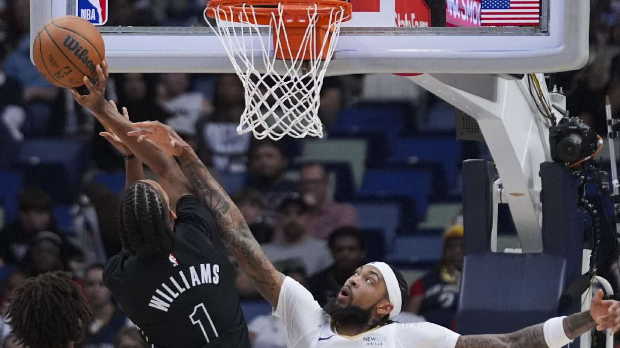 Brooklyn Nets forward Ziaire Williams (1) and New Orleans Pelicans forward Brandon Ingram battle under the basket in the first half of an NBA basketball game in New Orleans, Monday, Nov. 11, 2024.