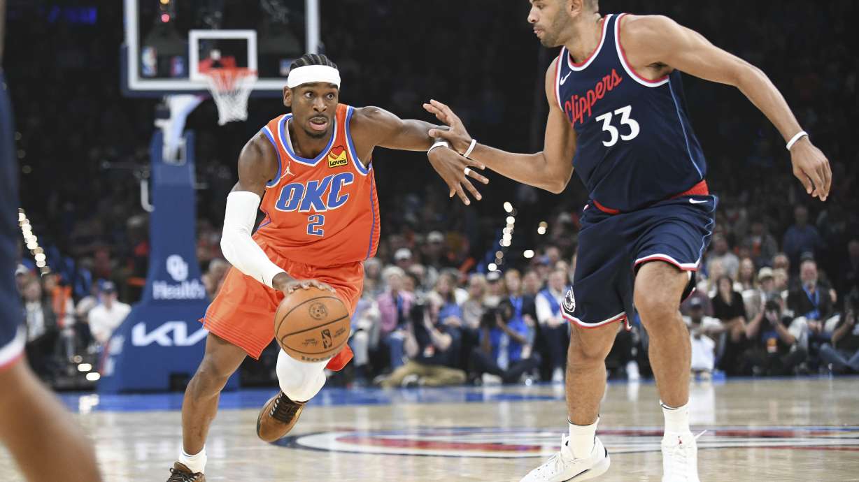 Oklahoma City Thunder guard Shai Gilgeous-Alexander (2) drives past Los Angeles Clippers forward Kawhi Leonard (33) during the first half of an NBA basketball game, Monday, Nov. 11, 2024, in Oklahoma City.